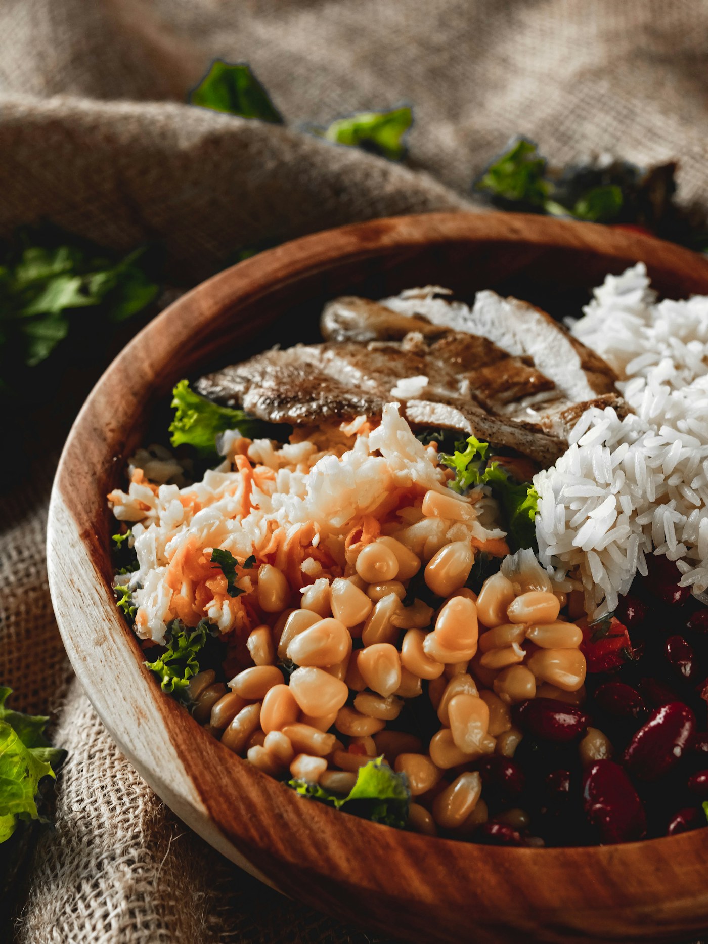 Balanced fish protein bowl with rice, vegetables, beans, and greens