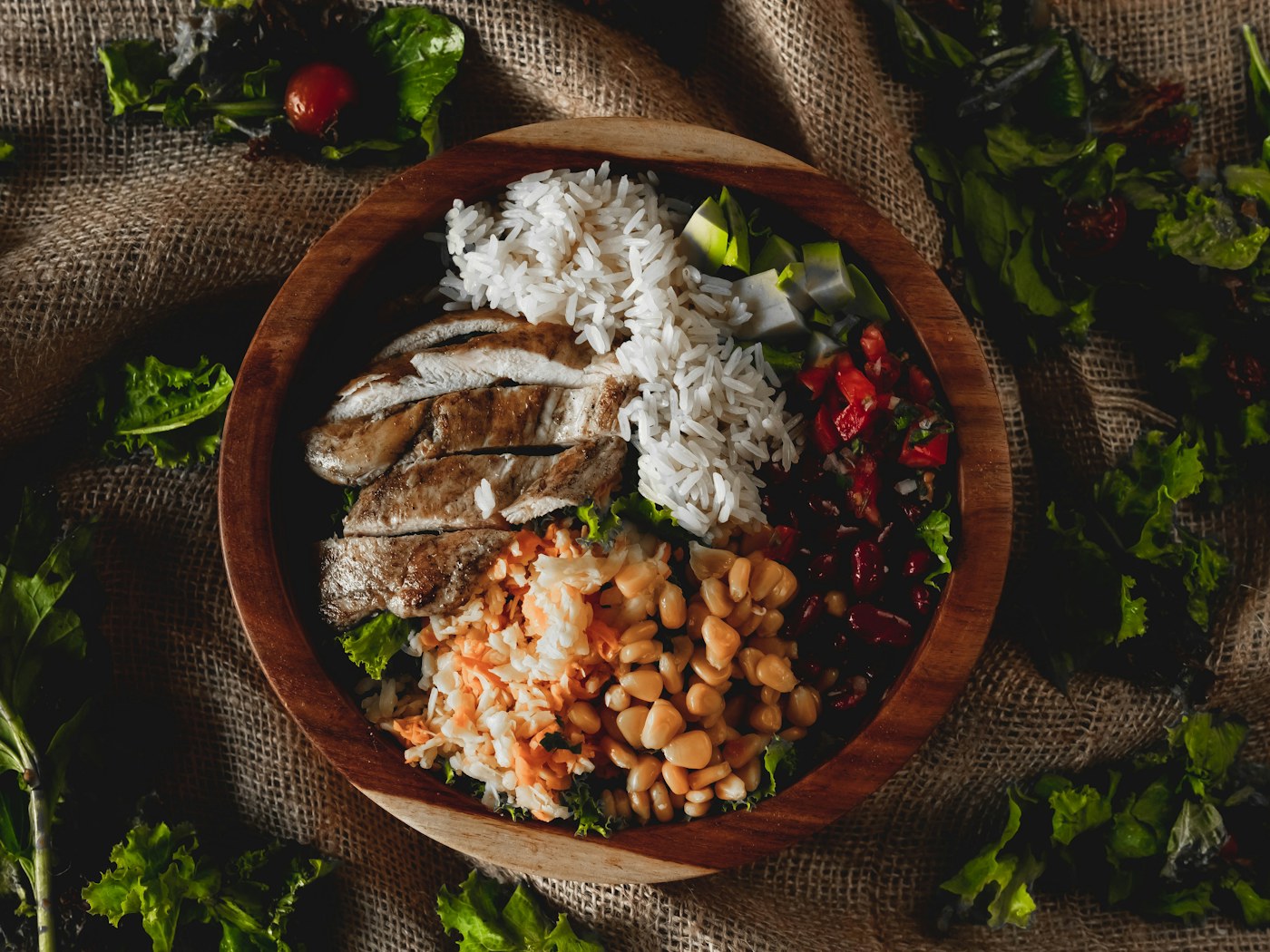 Chicken bowl with beans, corn, rice, vegetables, and lean protein