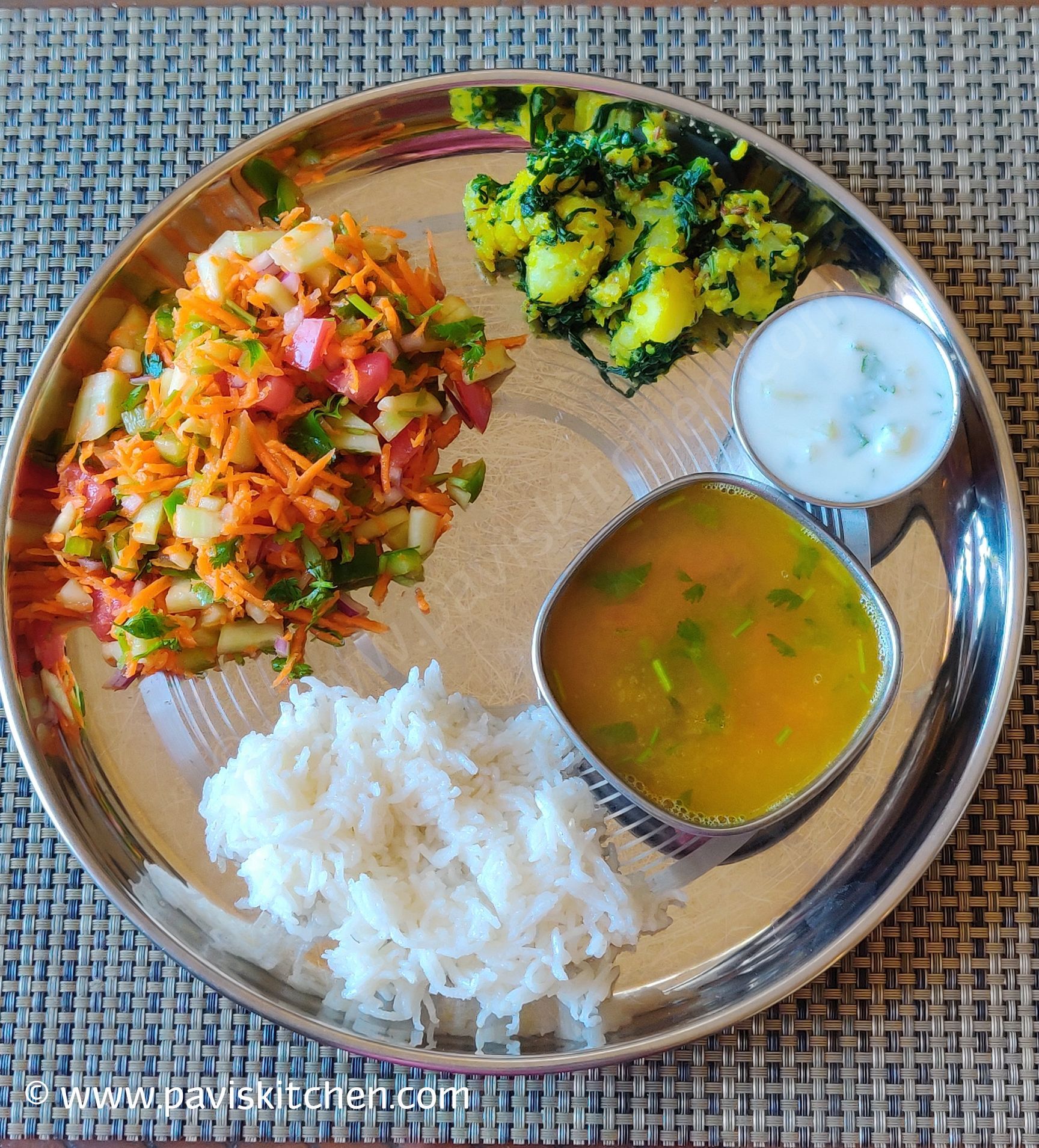 Balanced Indian plate with rice, dal, curd, salad, and cooked vegetables