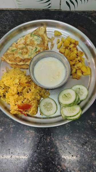 Balanced egg meal plate with rice, curd, potato, cucumber, and omelette